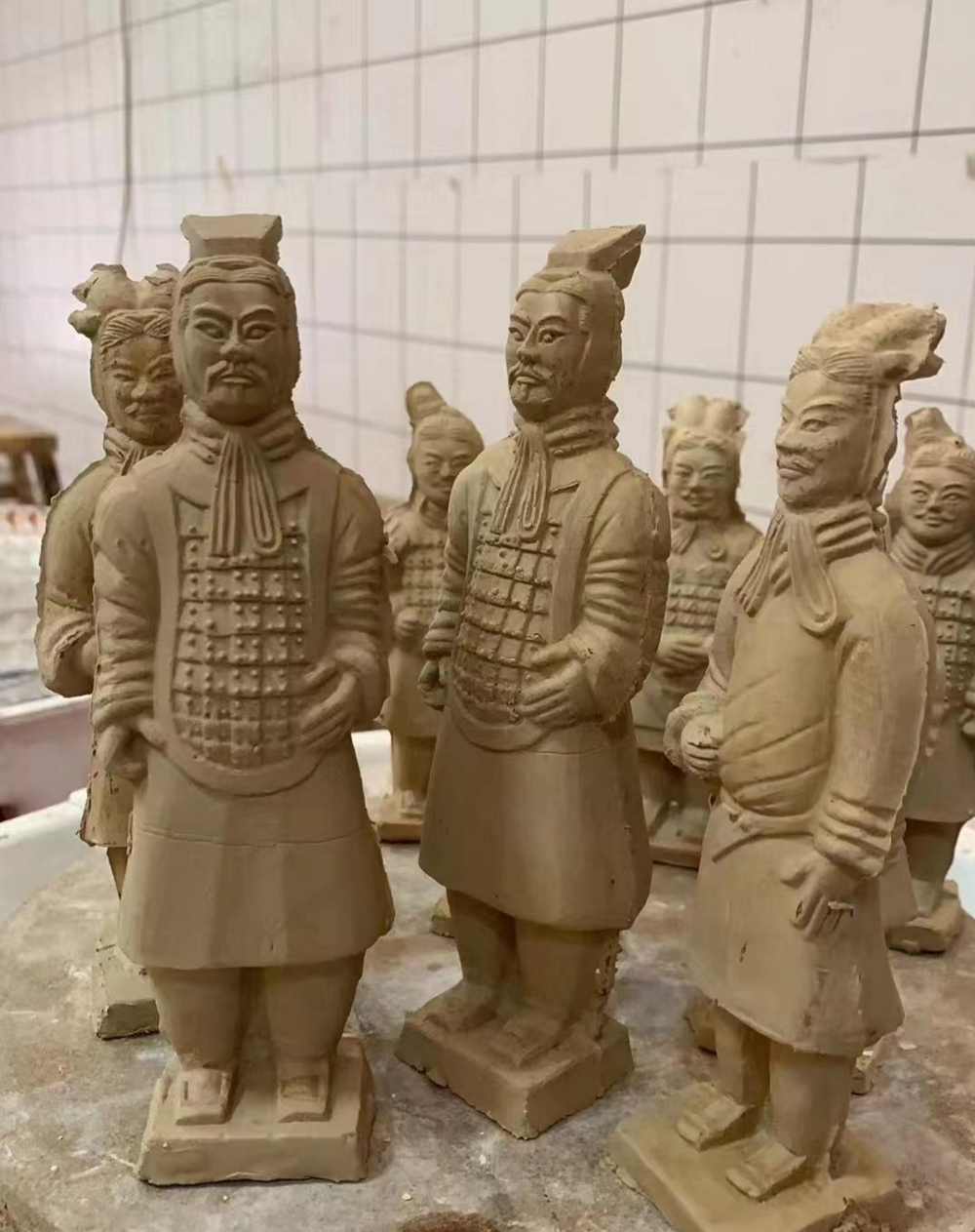 Traveler making handmade Terracotta Warrior clay figurine at craft workshop in Xi’an Shaanxi China, hands-on Qin Dynasty cultural experience arranged by Sunda Travel